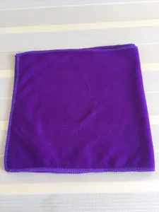 Macro detail view showing the soft and dense texture of a purple microfiber absorbent towel.