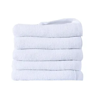 Close-up stack of five premium ultra-soft pure cotton white towels for hotel use
