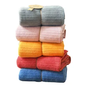 Stack of five soft absorbent coral fleece striped bath towels in assorted colors for home