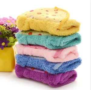 Close-up view of stacked colorful coral fleece hand towels featuring cute fruit patterns