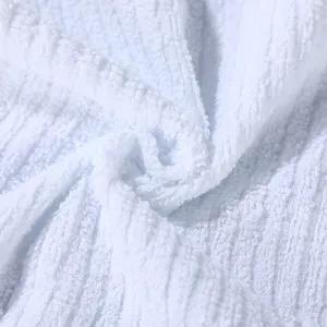 Close-up of white cotton striped towel with soft terry texture for hotels