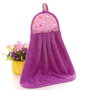 Macro detail view of soft purple coral fleece hanging hand towel with cute apple pattern
