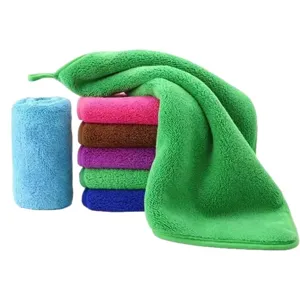 Multi-colored absorbent coral fleece towel with hanging loop for kitchen and home use.