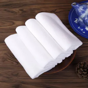 Close-up detail of four folded white absorbent microfiber square towels