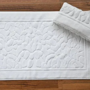 Pure white all-cotton thickened absorbent hotel bath mat with textured pebble pattern