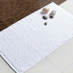 Premium white cotton non-slip bath mat with textured quilted pattern for bathroom spa