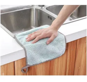 Close-up detail of soft absorbent microfiber kitchen cleaning cloth wiping a countertop