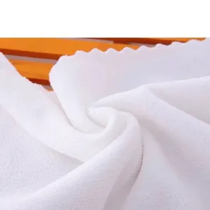 Ultra-soft white microfiber towel with decorative scalloped edges for hotel and home use