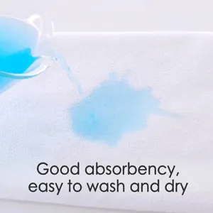 Highly absorbent white cotton square towel demonstrating fast water absorption with blue liquid