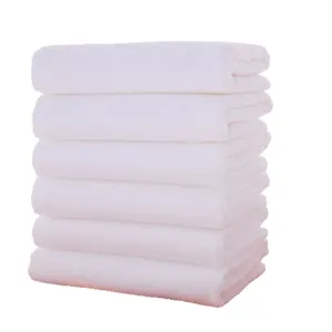 Premium stack of six soft absorbent white cotton towels for hotel spa and bathroom use