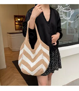 Model wearing a woven chevron pattern shoulder bag outside a minimalist bakery cafe scene.