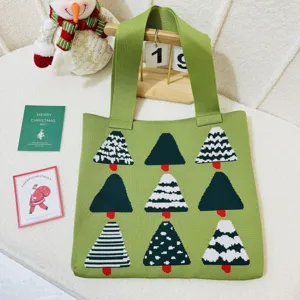 Macro view of a green knitted shoulder bag featuring various Christmas tree designs