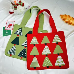 Detail of red and green knitted tote bags featuring various Christmas tree patterns.