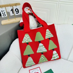 Red knitted tote bag featuring festive Christmas tree patterns for women holiday shopping.