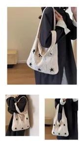 Elegant white knitted tote bag with black star motifs and textured cable patterns