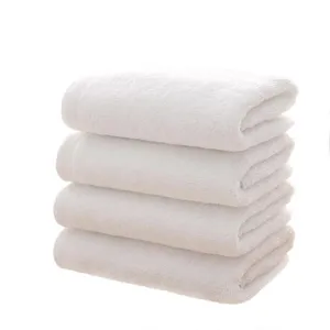 Premium stack of four thickened white cotton towels for professional hotel and spa use