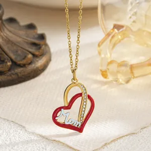 Close-up of gold heart pendant with red enamel and diamonds for Mother's Day