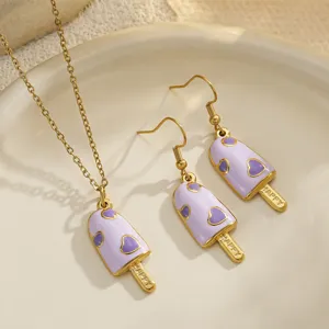Detail macro view of purple enamel popsicle jewelry set with heart patterns.