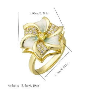 Detail view of a rotatable gold-plated flower ring with zircons and enamel petals.