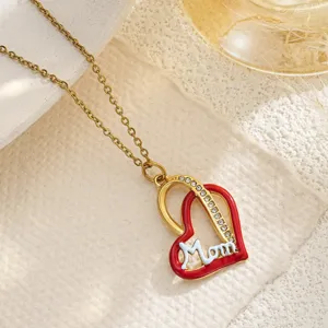 Close-up of heart pendant necklace with red enamel and Mom script for Mother's Day