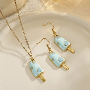 Detailed view of light blue enamel popsicle earring and necklace set with heart patterns