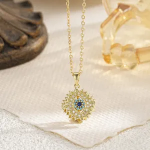 Close-up of a rotating gold evil eye pendant with turquoise and sparkling cubic zirconia stones