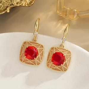 Detailed view of vintage New Chinese style red crystal earrings with gold lattice