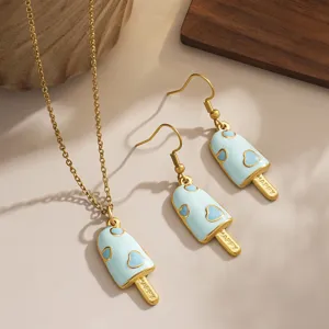 Close-up view of light blue enamel popsicle jewelry set with engraved HAPPY text