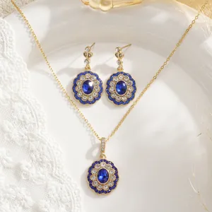 Macro view of vintage royal jewelry set featuring blue sapphire pendants with gold finish