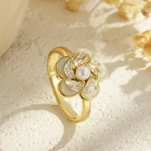 Macro detailed view of elegant gold-plated flower ring featuring a rotating pearl center