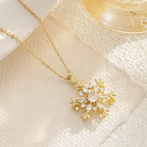 Close-up of rotatable golden snowflake pendant necklace with sparkling zircon inlays