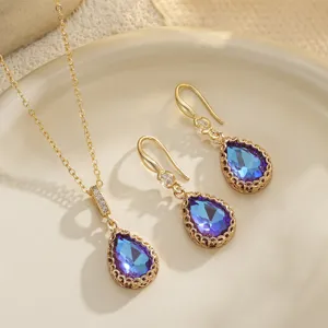 Detailed macro view of an elegant waterdrop blue crystal necklace and earrings set