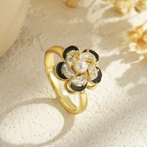 Detailed view of elegant rotatable flower ring with pearl, black enamel and crystals