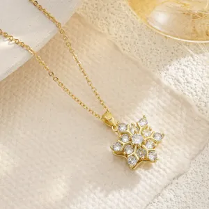 Elegant gold snowflake rotating pendant necklace featuring brilliant cubic zirconia