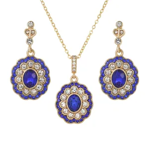 Vintage palace style gold jewelry set with oval blue sapphire pendant and earrings