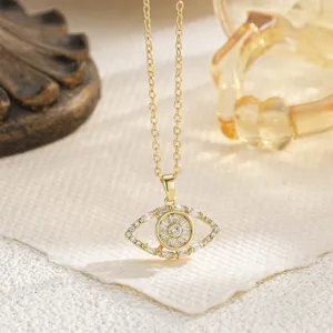 Detailed macro view of rotatable gold-plated Evil Eye pendant with crystal inlay