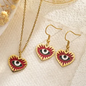 Detailed view of the heart-shaped evil eye enamel necklace and earrings set in gold