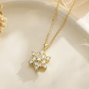 Macro view of a gold-plated rotatable snowflake necklace with sparkling zircon stones
