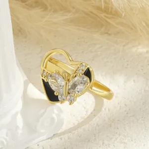 Detailed close-up of a gold-plated heart ring featuring a rotating butterfly with zirconia