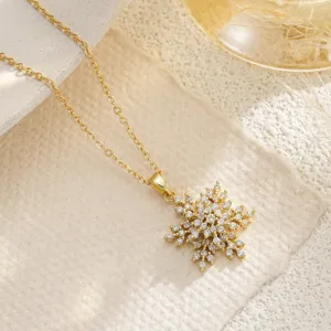 Detailed view of gold snowflake necklace pendant featuring sparkling cubic zirconia