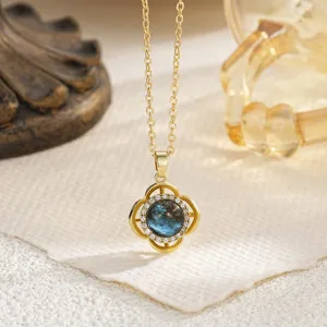 Detailed close-up of rotatable Evil Eye pendant with sparkling stones in gold finish