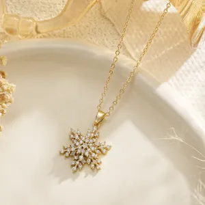 Detailed macro view of a gold snowflake necklace pendant with shimmering zircon stones