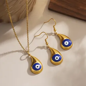Detailed view of gold-plated evil eye necklace and earring set with blue enamel