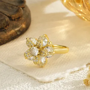 Detailed macro view of a gold flower rotating ring with clear cubic zirconia stones
