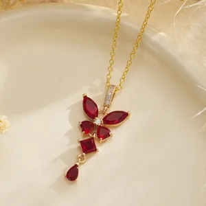 Detailed view of an elegant vintage gold necklace with ruby-red zircon floral pendant