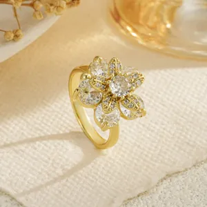 Macro view of an elegant gold rotating flower ring featuring sparkling clear zircon petals