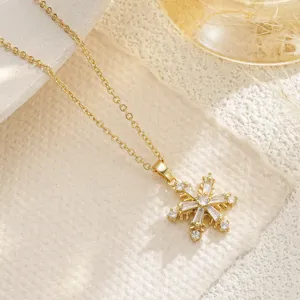 Macro view of gold snowflake rotatable pendant necklace with zircon inlay detail