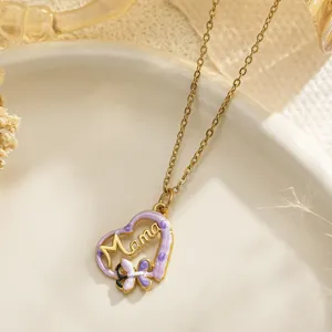 Close-up of gold stainless steel heart necklace with purple enamel and Mama pendant