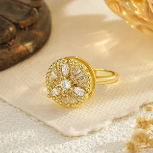 Close-up of rotating gold-plated ring with sparkling marquise cubic zirconia stones