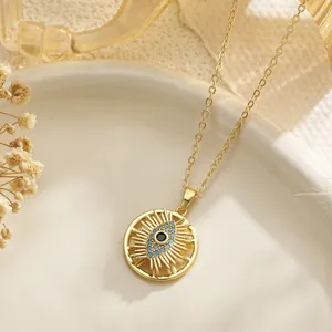 Rotating Evil Eye necklace with golden sunburst pendant and blue stone inlay.